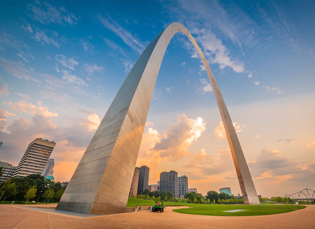 About Our Agency - View of the Gateway Arch in Downtown St Louis Missouri Against a Colorful Cloudy Sunset Sky