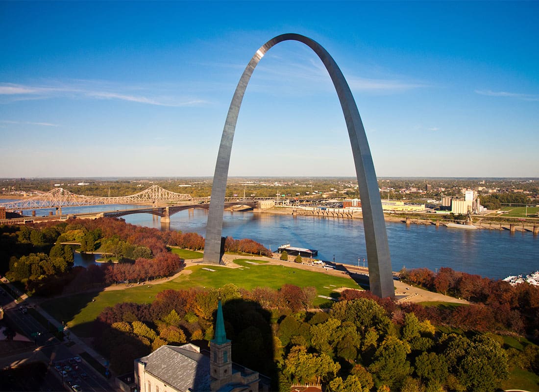 We Are Independent - View of the St Louis Missouri Arch in a Park with Fall Colored Trees by the River on a Sunny Day